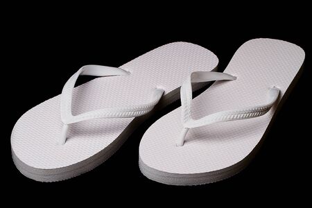 White sandals isolated on black backgroundの写真素材