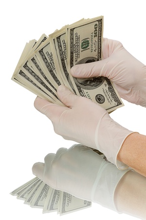 Hands in gloves believe Dollars. Isolated on white backgroundの写真素材