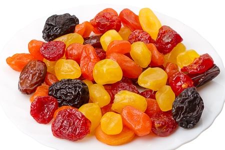 Heap dried fruit (prunes, apricots, figs, dogwood, date) on a white plate の写真素材