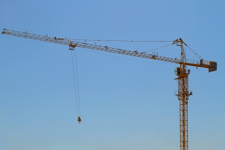 The construction crane is yellow in the sky.  Copy spaceの写真素材