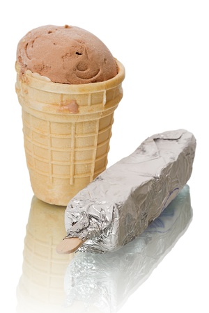 Chocolate ice cream in a waffle cup and ice cream on a stick in foil. Isolated on white background.の写真素材