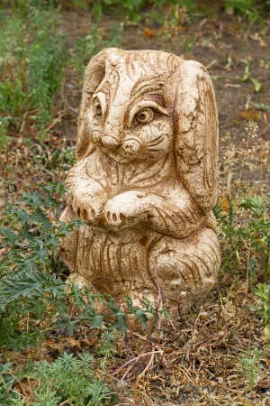 Ceramic sculpture of a rabbit with a glaze in the gardenの写真素材