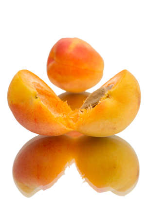 Apricot with halves isolated on white backgroundの写真素材