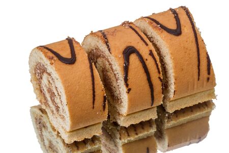 Sliced ââcake roll isolated on white backgroundの写真素材