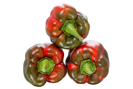 Three reddish sweet peppers  Isolated on white backgroundの写真素材