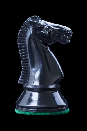 Black knight - one of 12 chess pieces   Isolated on black backgroundの写真素材