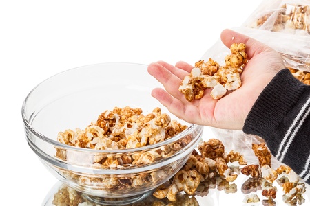 Child with sweet popcorn covered with syrupの写真素材