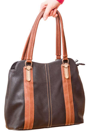 Leather woman handbag in hand isolated on white backgroundの写真素材