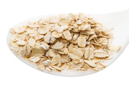 Oat Flake in a plastic spoon isolated on a white backgroundの写真素材