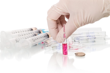 Human hand, used syringes and vial  isolated on white backgroundの写真素材