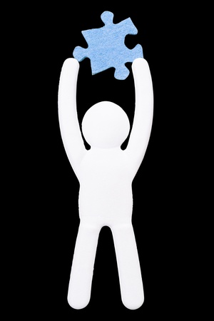 Paper manikin with Blank Puzzle isolated on a black backgroundの写真素材