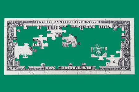 Puzzles one dollar isolated on a green backgroundの写真素材
