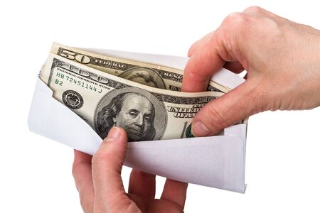 Hands and envelope with cash in dollars isolated on white background