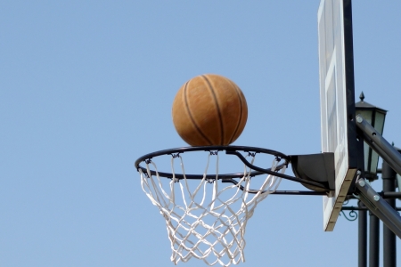 Basketball hoop and ball flying outdoorsの写真素材