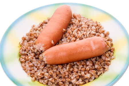 Two sausages on a plate with buckwheat  On  white backgroundの写真素材