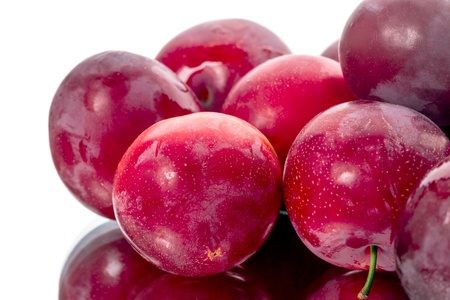 Pile of red plum isolated on a white backgroundの写真素材