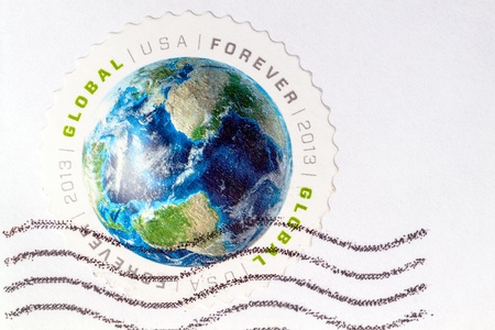 Globe on a round postage stamp   Copy spaceのeditorial素材