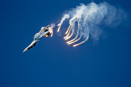 Tambov, Russia -  May 31, 2014   Traditional air show in Tambov  Jet fighter aircraft Su-27  Flanker  and  infrared countermeasure  IRCM  against blue sky background   のeditorial素材