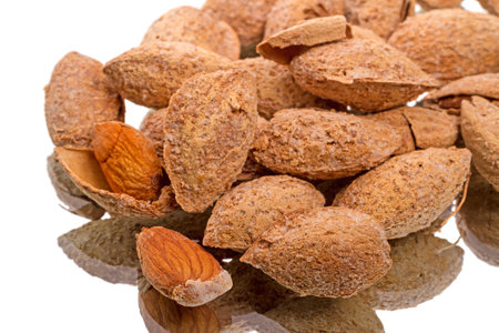 A pile of salted almonds isolated on white background