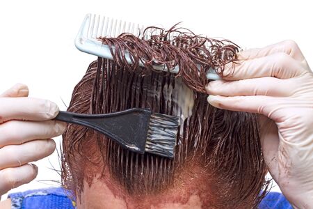 Hair coloring with his hands, isolated on a white 