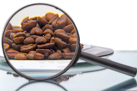 Coffee beans on electronic scales and magnifierの写真素材