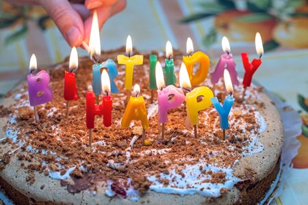 Homemade Cake with burning candles on birthdayの写真素材