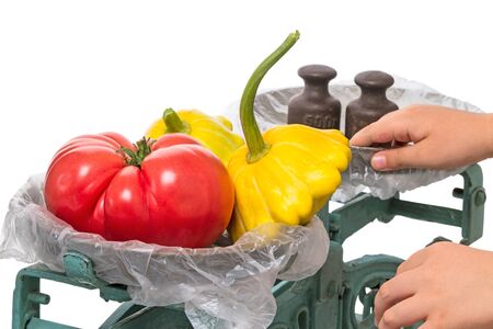 The old mechanical scales with vegetables isolated on white backgroundの写真素材