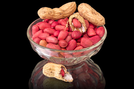 Peanuts in a bowl of glass isolated on a black background