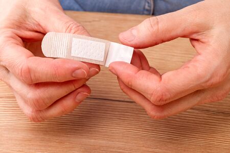 Hand  with medical plaster prepares it for use