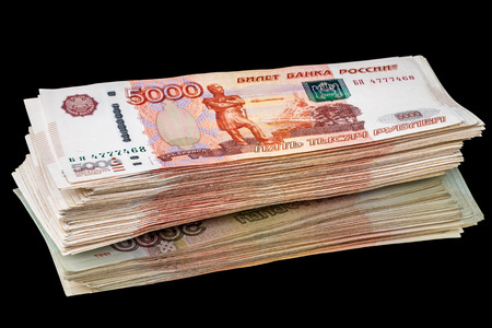 Half a million of Russian paper money 5000 rubles on the mirror. Isolated on a black background