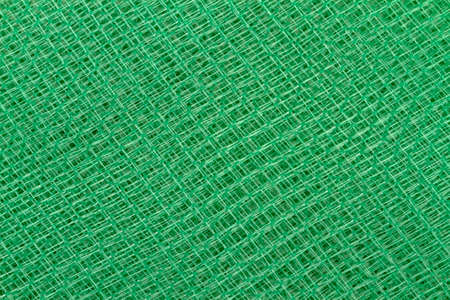 Abstract background of green plastic meshの写真素材