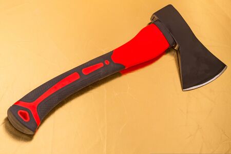 New ax with a red handle on a gold backgroundの写真素材