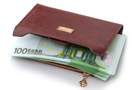 Heap of hundred euros in banknotes in a wallet isolated on white backgroundの写真素材