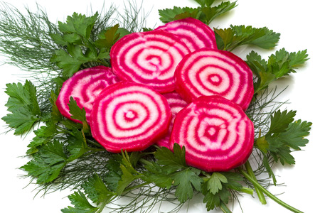 Sliced beet with white veins and herbs on white backgroundの写真素材