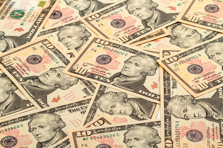 Background of a large number of new banknotes  ten dollars. Type acute angle