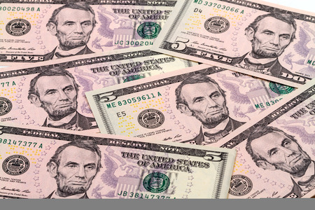Background from banknotes five dollar. Type acute angle