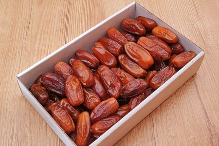 Algerian dried dates (tropical fruit) in an open boxの写真素材