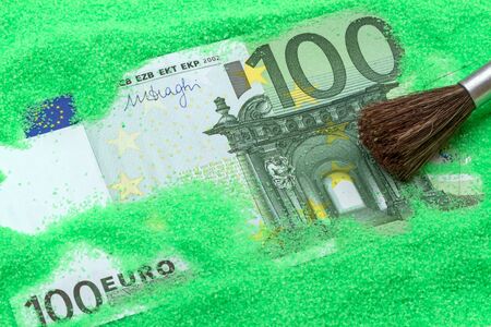 Banknote one hundred euros in the green sand and brushの写真素材