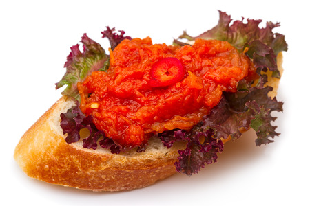 Homemade sandwich with vegetable caviar on salad leaf isolated on white backgroundの写真素材