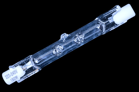 Glass bulb of halogen lamp isolated on black backgroundの写真素材