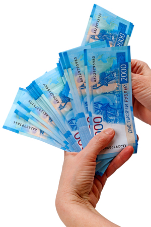 Hand with new denomination of Russian paper money 2000 rubles on a white backgroundの写真素材