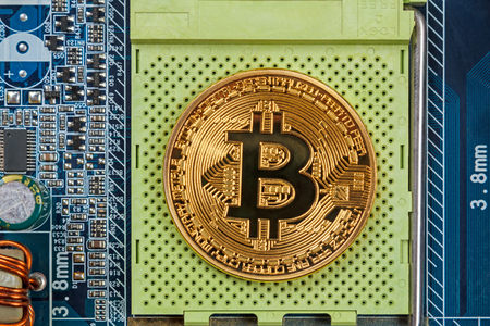 Coin Bitcoin on the CPU socket of the motherboardの写真素材
