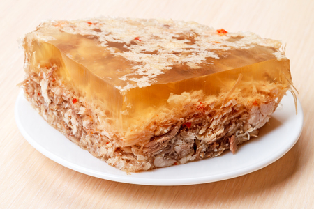 A piece of jelly from meat products on a white plateの写真素材