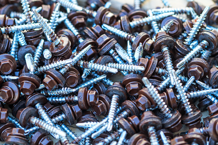 Background of galvanized brown roofing screwsの写真素材