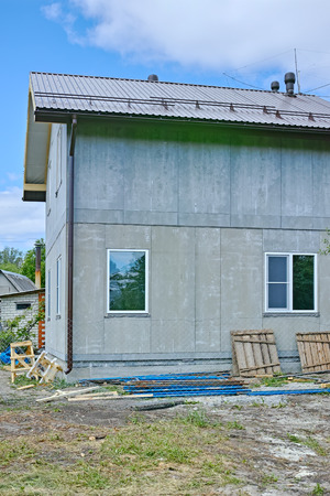 Drainage system of a two-story frame house from cement boardの写真素材
