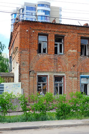 Old brick house to demolition and a new buildingの写真素材