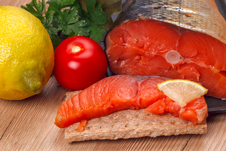 Smoked wild Far Eastern salmon with lemon and vegetablesの写真素材