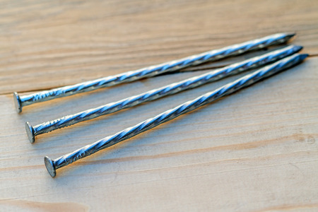 Three galvanized twisted nails. Building your homeの写真素材
