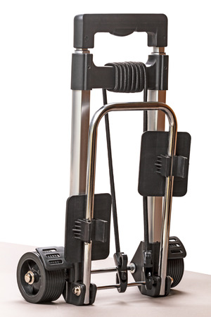 Trolley for hand luggage in the folded state on whiteの写真素材