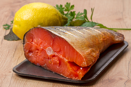 Smoked wild Far Eastern salmon with lemon and vegetablesの写真素材